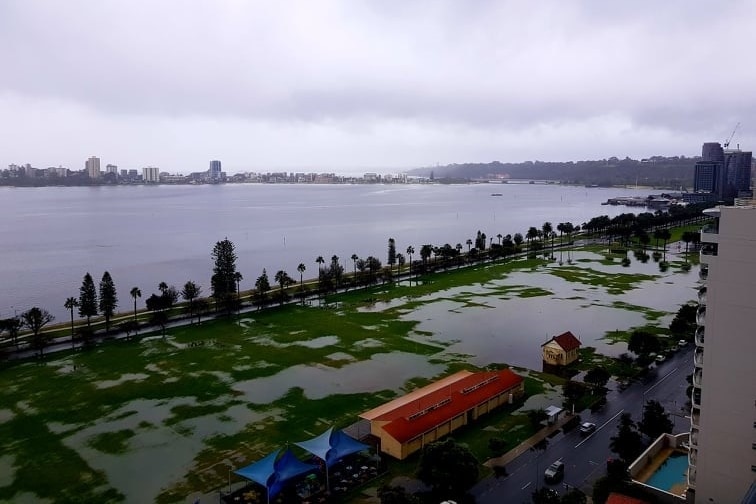 Water pools on the ovals of Langley Park in this aerial view. The river is in the background, angry and grey.