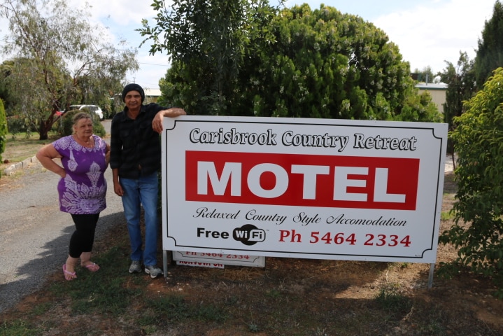 Robert and Carol Soewardie stand outside the motel they helped their son purchase
