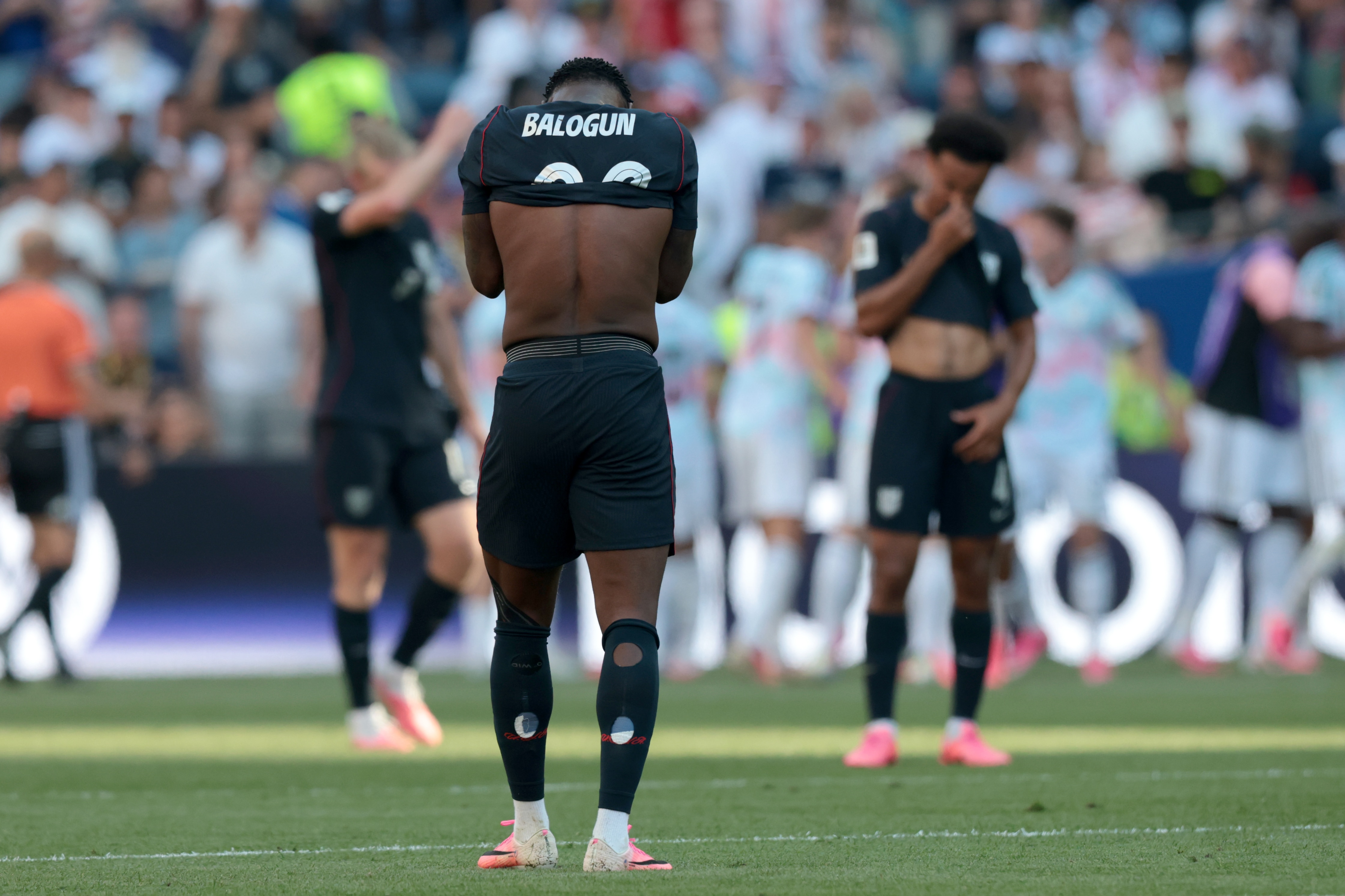 Folarin Balogun pulls his shirt over his face in disappointment