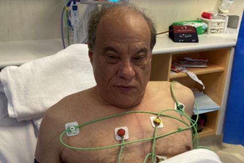 An elderly man lying in bed in hospital