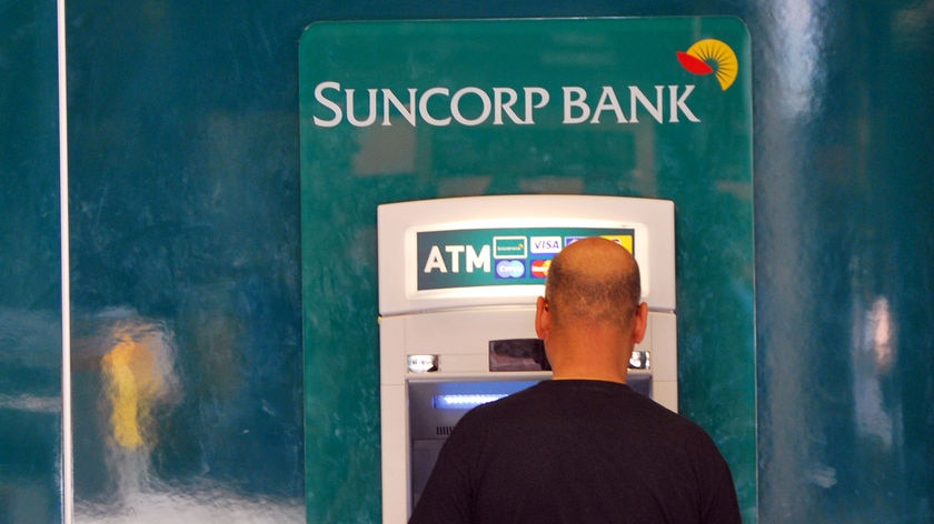 A man withdraws money from a Suncorp ATM in Brisbane.