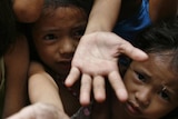 Poverty-stricken children reach for food (Reuters: Romeo Ranoco)