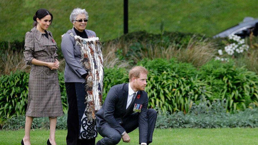 Prince Harry kneels in traditional Maori welcome ceremony