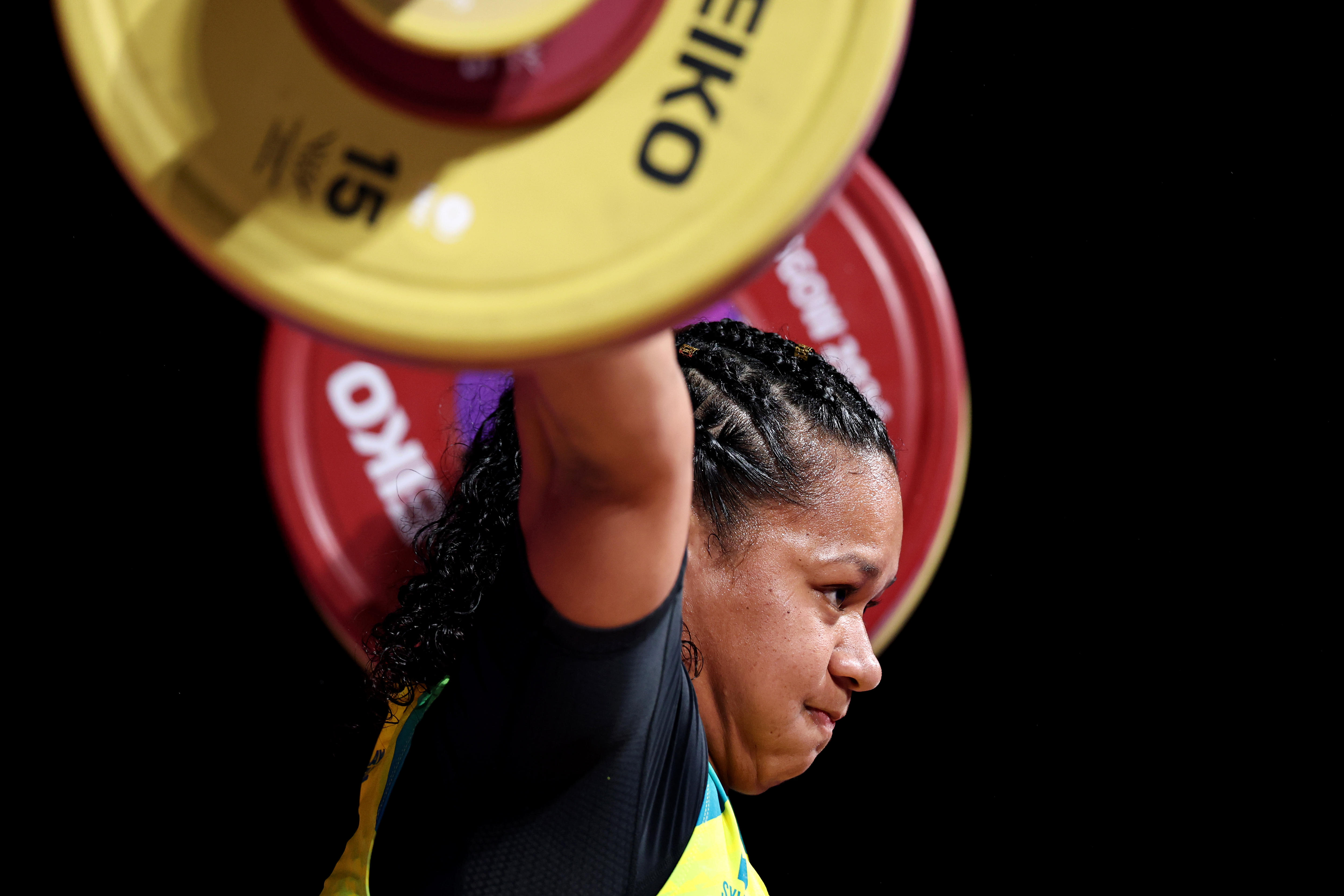 A woman competes during the weightlifting.