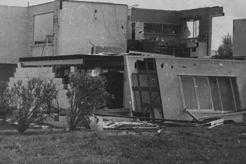 Black and white picture of a house destroyed.