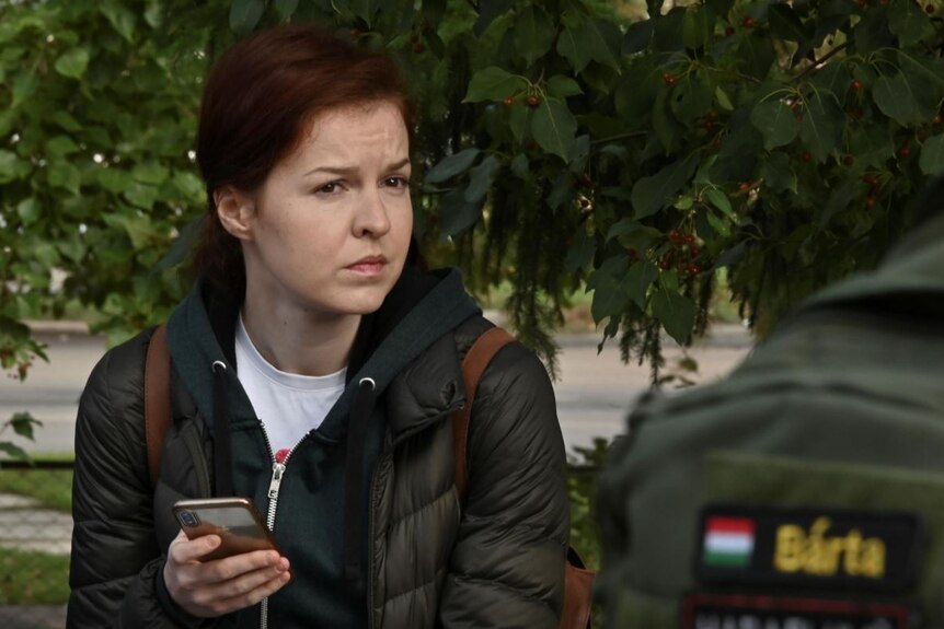 Red-haired woman wearing black coat