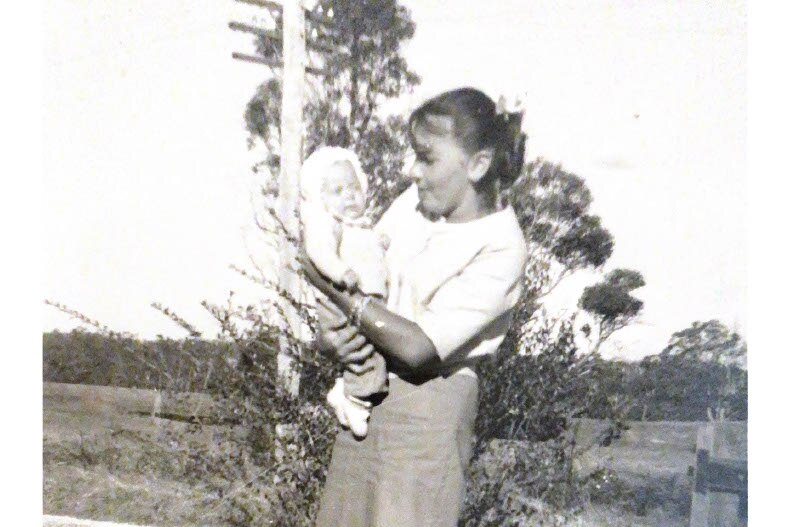 A woman holding a baby