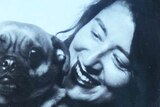 Joanna Nilson's black and white Twitter profile shows her posing with a pug dog.