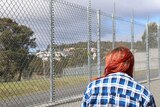 Amy at prison fence