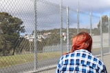 Amy at prison fence