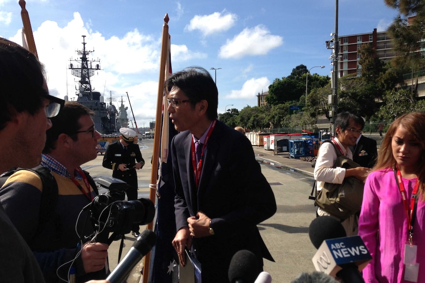 Media and a Japanese delegate have a heated conversation