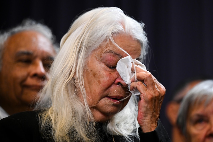 Marcia Langton wipes tears during the announcement of the Voice to Parliament wording