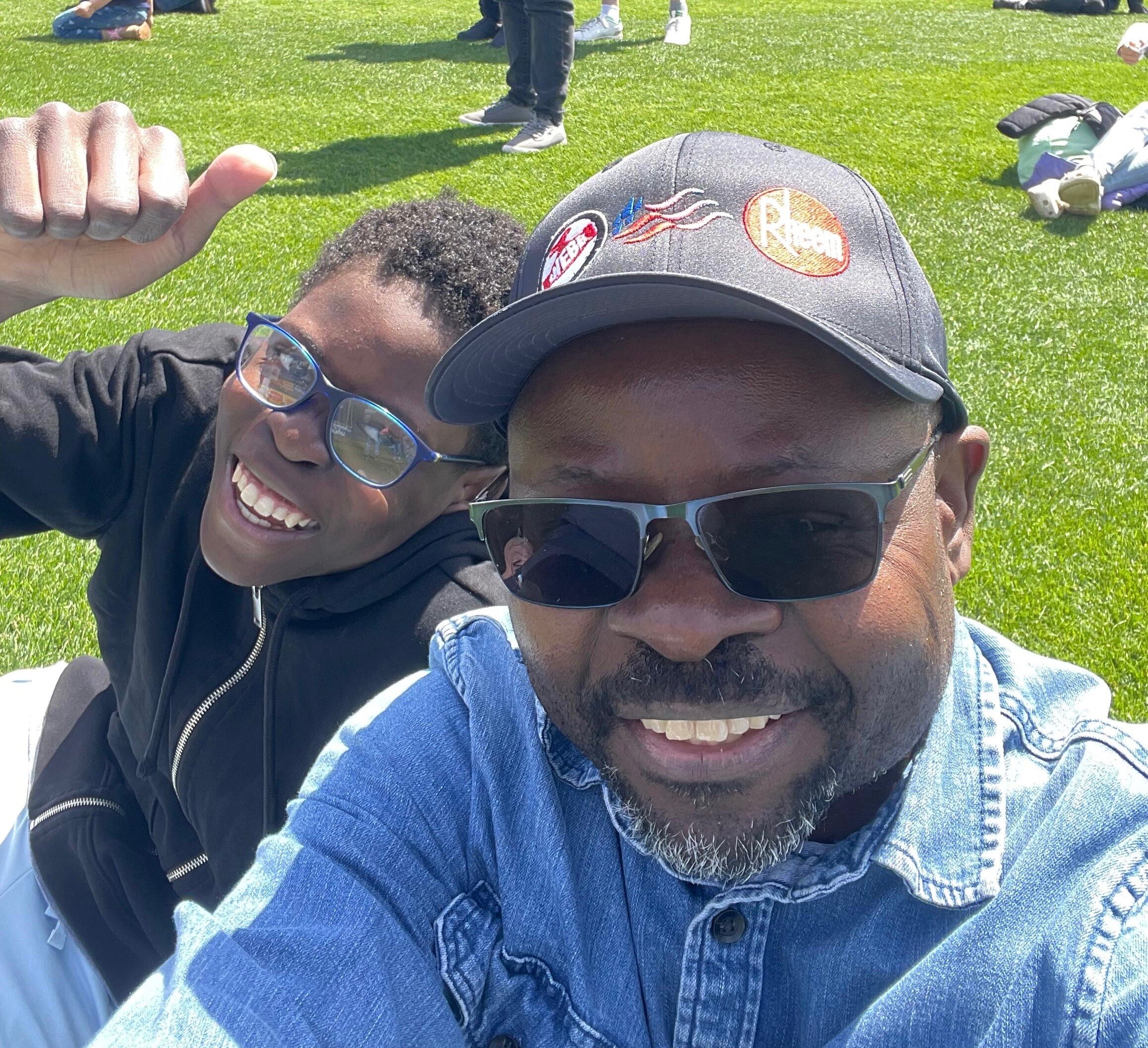 Nguinamau Celestino and his son smile for the camera.