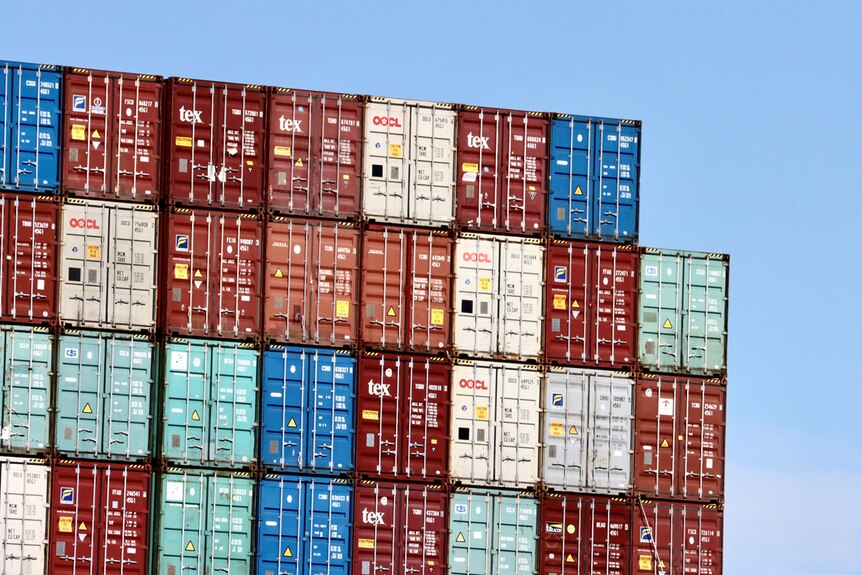Shipping containers are stacked at a port