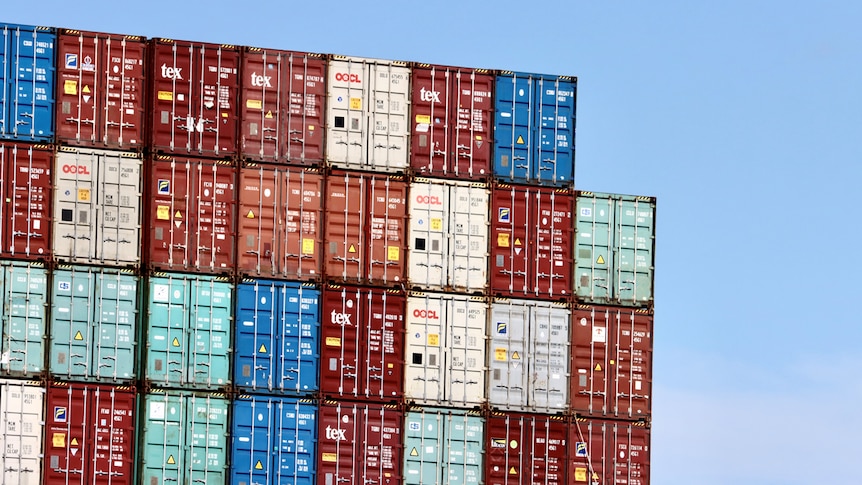 Shipping containers are stacked at a port