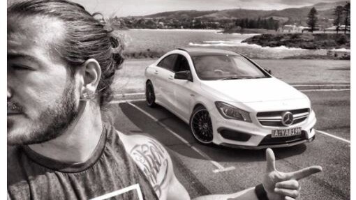 A Facebook post featuring an inspirational message and a man in front of a white Mercedes.