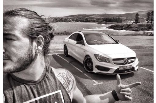 A Facebook post featuring an inspirational message and a man in front of a white Mercedes.