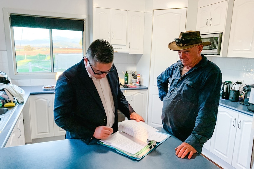 Lawyer Jonathan Walsh with Tony Kotlin in Mr Kotlin's kitchen in his house.