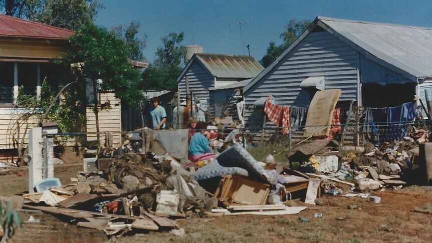 People outside a flood-damaged home in Charleville in 1990