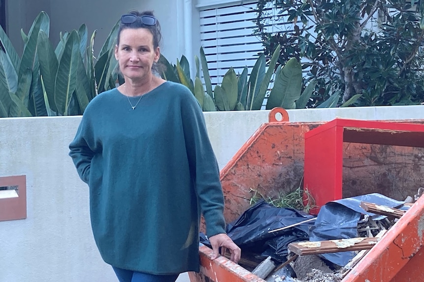 Tanya Ryall stands outside her Ashgrove home in Brisbane with skip bin.