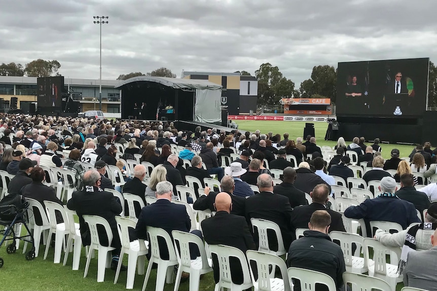 Mourners at Alberton Oval for the state funeral of Port Adelaide Magpies legend Russell Ebert.