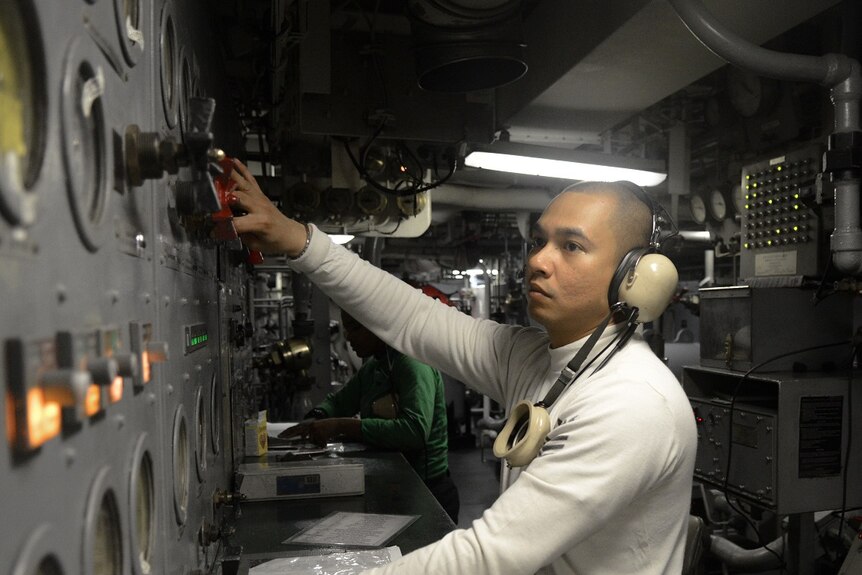 A sailor on board the USS Reagan.