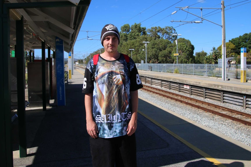 Blake Malone stands alone on the platform at the Seaforth train station.