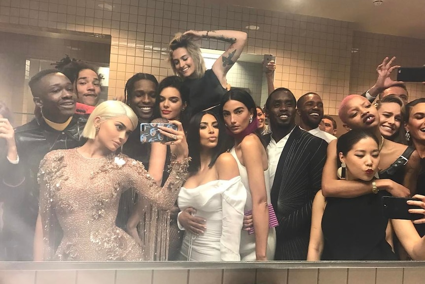A group of celebrities in a bathroom. 