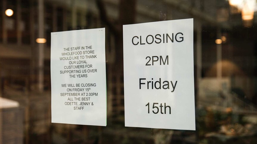 A closing down sign on a window.
