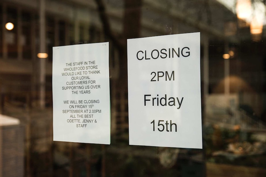 A closing down sign on a window.