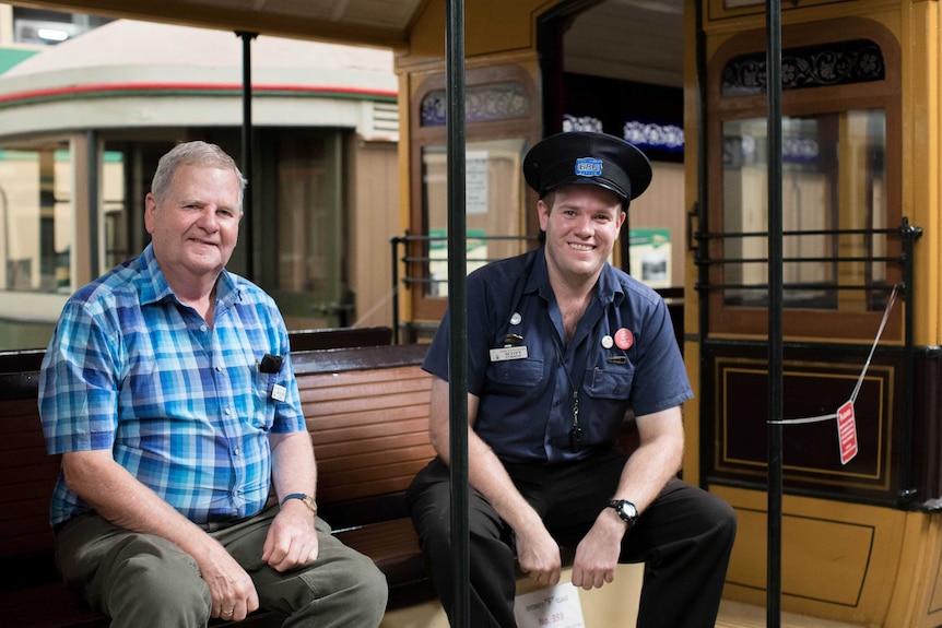 Howard Clarke and Scott Curnow sit on an old tram