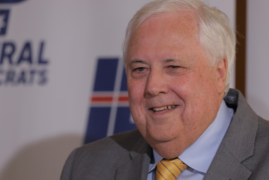 Clive Palmer grinning at a press conference. 