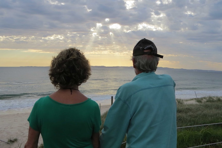 A couple look towards the sunrise from Bribie Island