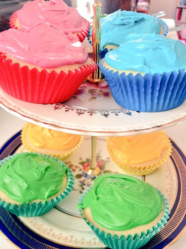 Cupcakes with colourful icing on a cake stand