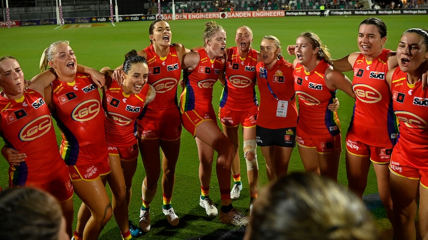 The Suns celebrate after winning the round 10 AFLW match
