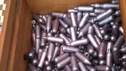 A box full of empty nitrous oxide canister, or nangs