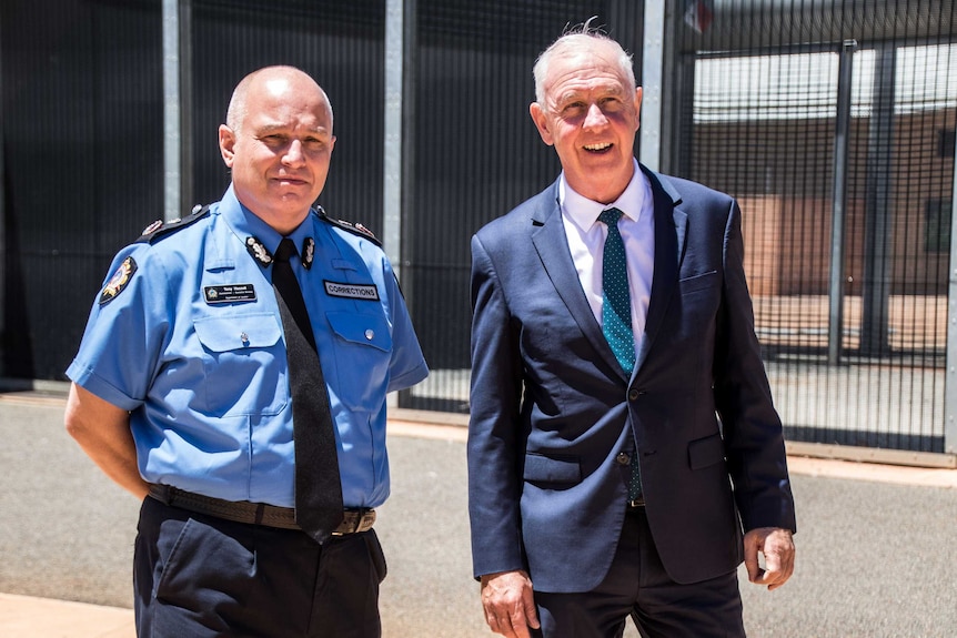 Two men standing outside prison