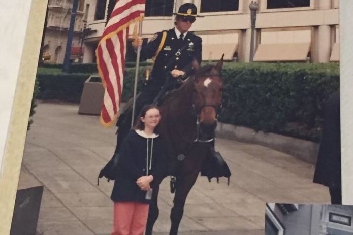 Julia Hales as a young woman, standing next to a man on a horse in London.