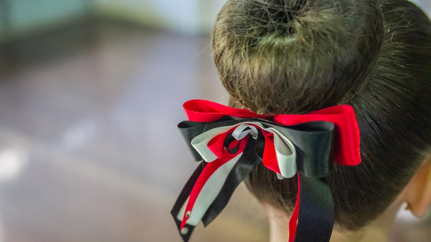Young student Scarlett Handy has her hair in ribbons as she practises her steps.