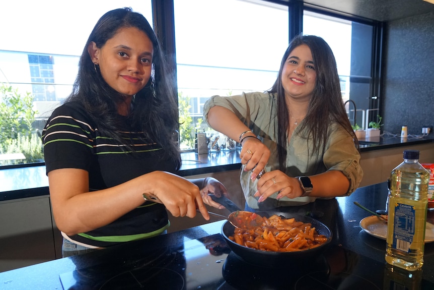 Two young women cooking