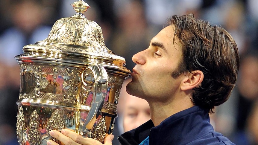 Federer wins Swiss Indoors and celebrates with trophy