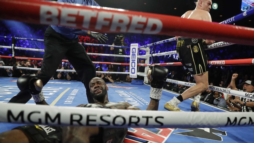 Deontay Wilder is seen on the canvas after being knocked down by Tyson Fury in their heavyweight boxing bout.