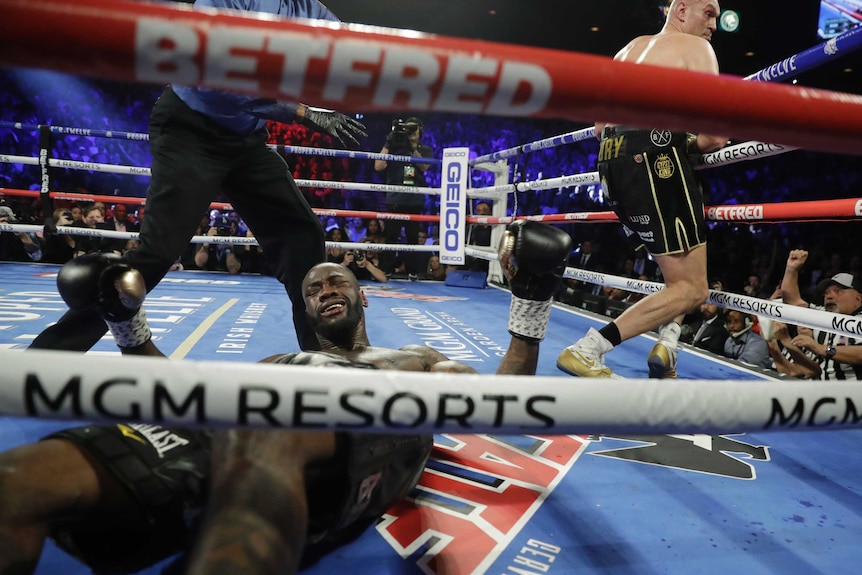 Deontay Wilder is seen on the canvas after being knocked down by Tyson Fury in their heavyweight boxing bout.
