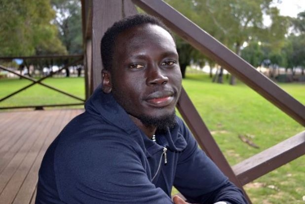 Perth runner Makur Chuot looks at the camera on a veranda.