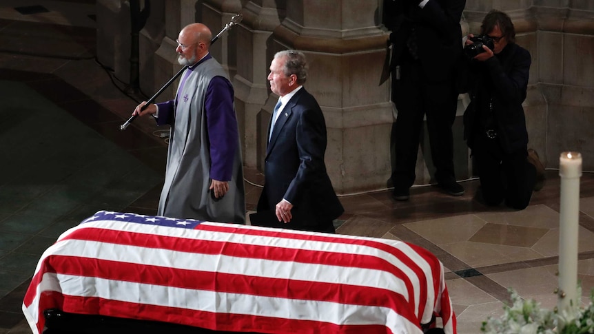 George W. Bush walks away after speaking at a memorial service for Senator John McCain.