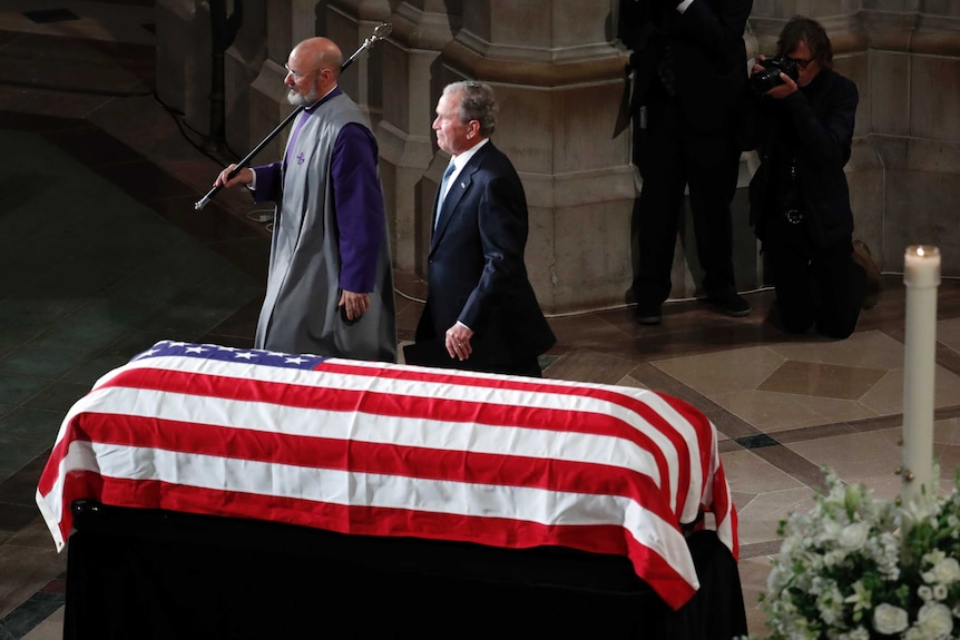 George W. Bush walks away after speaking at a memorial service for Senator John McCain.