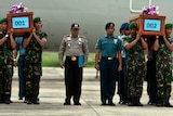 Indonesian military personnel carry coffins of victims, East Java, December 31, 2014