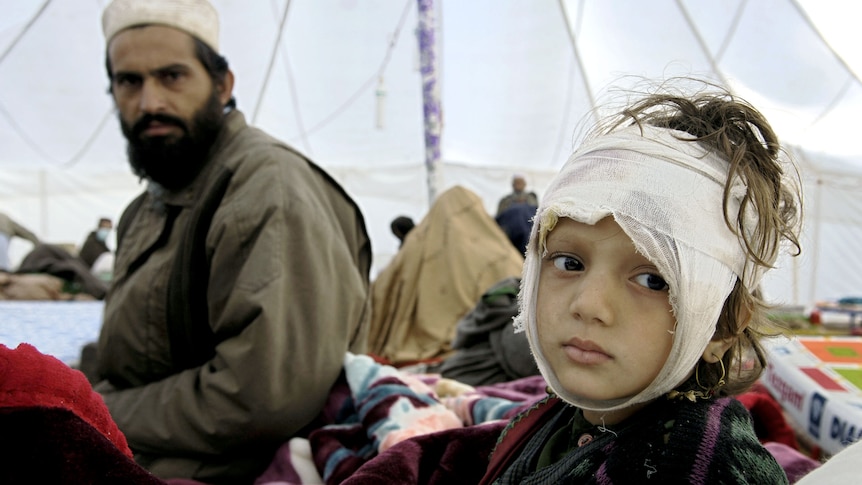 A Kashmirii girl awaits treatment in a Save the Children tent