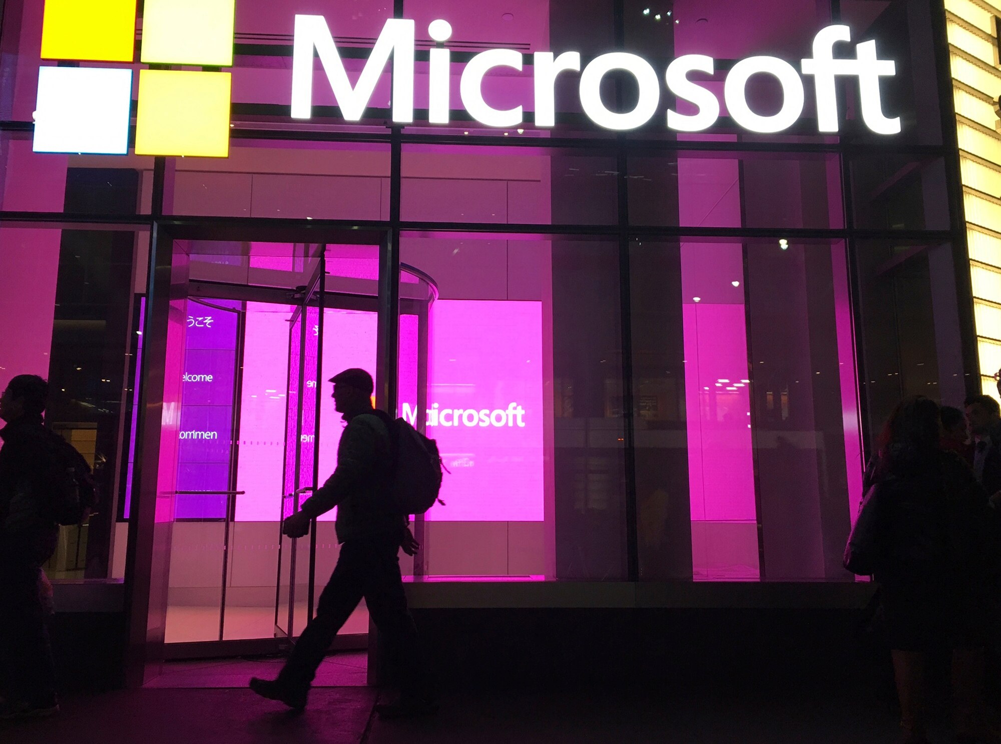 People walk near a Microsoft office in New York