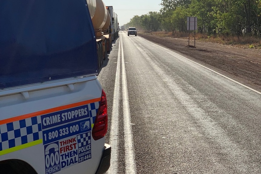 A line of traffic waits for the Stuart Highway to reopen